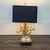This unique table lamp features a striking gold faux coral-shaped base with realistic texture and detail. The lamp has a...