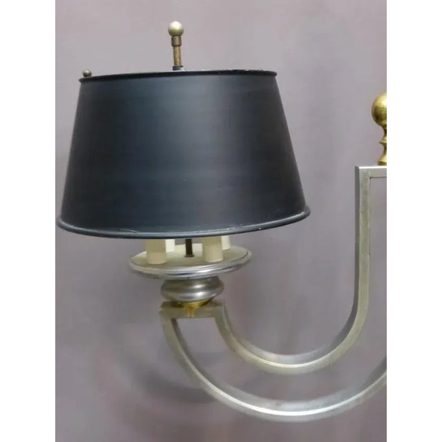 Modernist chandelier medium XX in brushed metal and brass which has a double lighting, eight lights in total. The...