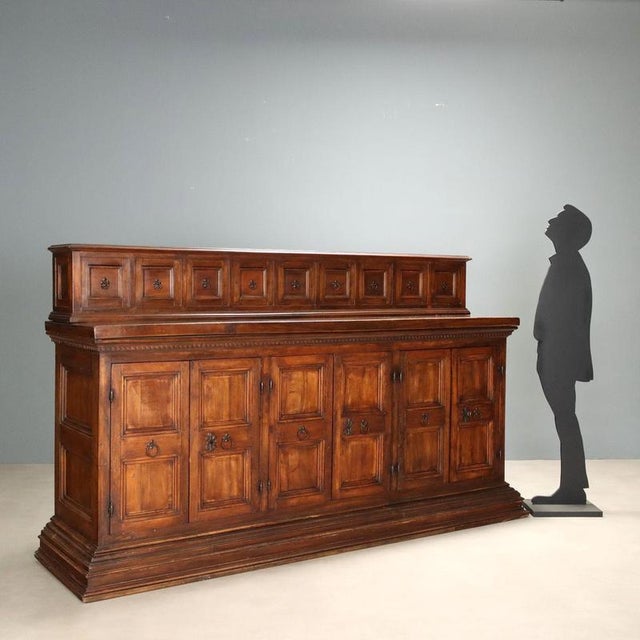 Baroque style sideboard made of walnut and poplar, dating back to the first half of the 20th century. The piece features a...