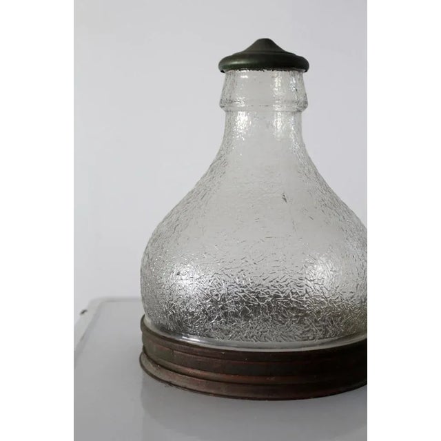 This pair of vintage warehouse light shades dates to the 1930s and features clear patterned glass bodies with metal base...