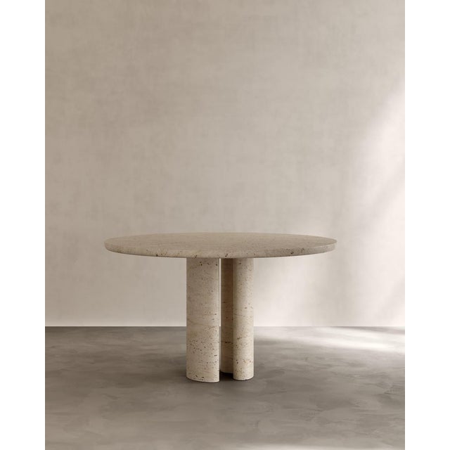 Roman dining table ii in roman travertine by paloma editions dimensions: d 130 x w 130 x h 75 cm. Materials: travertine....