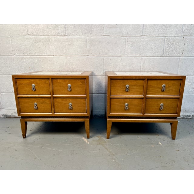 Striking mid-century modern bedroom set featuring a maple headboard and matching pair of nightstands with decorative...