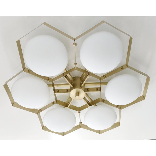Italian midcentury flush mount with six matte white Murano glass shades mounted on solid brass frame in satin brass finish...
