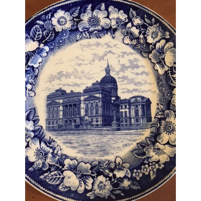 Two beautiful antique flow blue souvenir plates. One is of the Indiana State Capitol Building and the other is of Rhode...