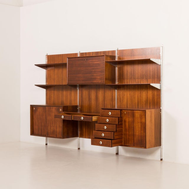 This extremely elegant italian mid-century rosewood wall unit was designed by georges coslin and manufactured by 3v...