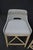 Set of three woven counter stools by Essentials For Living featuring a light natural wood frame, woven open-back seat...
