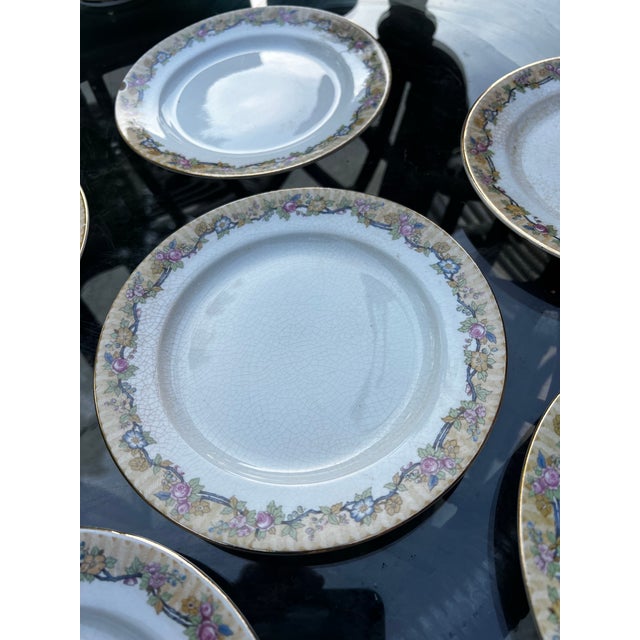 Up for consideration is a beautiful vintage collection of United Wilson Porcelain plates with floral edges. These would...