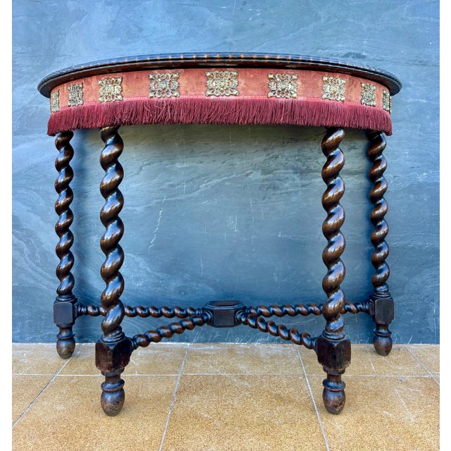 Striking Spanish Baroque style demilune console table dating to the early 20th century. The table features a semi-circular...