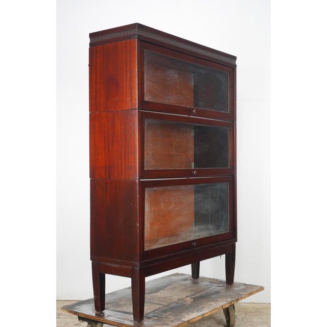 Antique three section mahogany barrister bookcase with steel hardware. Barrister bookcases were originally designed for...