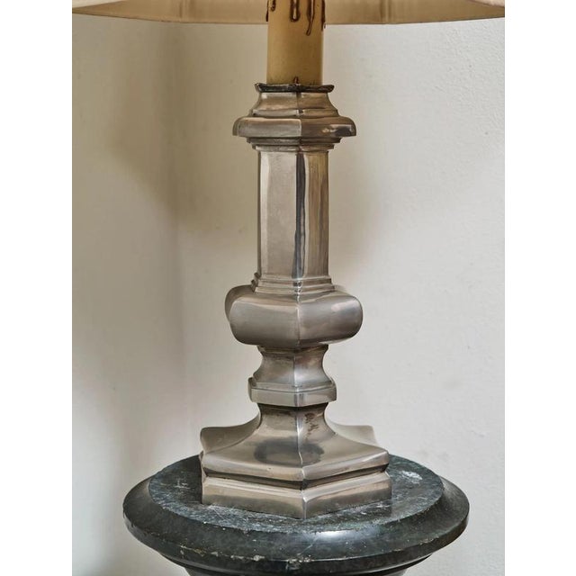 Probably from the lucien gau workshop, paris. The lamp is made of solid metal, with a distinctly architecturally...
