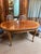 Georgian-style Karges burl walnut table boasts a solid build and is in excellent condition. Single top leaf with ability...