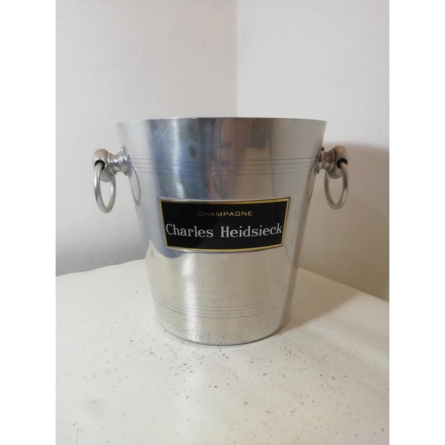 Charles Heidsieck Champagne ice bucket. Made of aluminum with a winery advertising plaque. Marked "Made in France" on the...