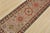 A tribal Caucasian Kazak runner hand-knotted with fine wool on a cotton foundation. This rug features geometric medallions...