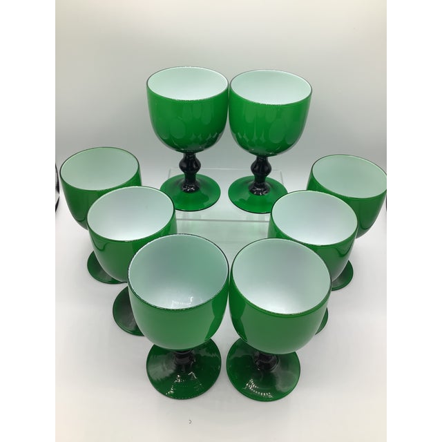 A gorgeous set of eight emerald green with white, 1960s hand blown Murano Carlo Moretti wine glasses/goblets. The measure...
