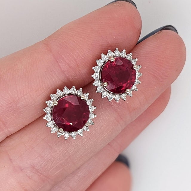 These beautiful stud earrings feature a pair of 5.78 carat weight round ruby gemstones with natural earth mined diamonds,...