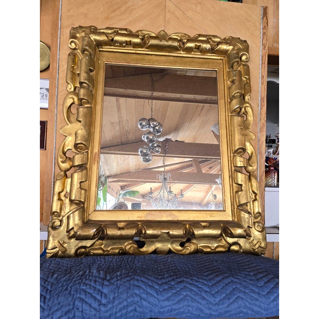 A large and impressive antique 18th century carved mirror with it's original gold leaf gilding. Having elaborate carved...
