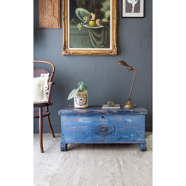 This rustic 19th-century painted blue cedar blanket chest trunk features artfully applied layers of multiple blues with...