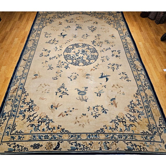 An exquisite 19th century oversized Chinese Peking rug of great scale and refinement, showcasing a serene ivory field...