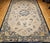 An exquisite 19th century oversized Chinese Peking rug of great scale and refinement, showcasing a serene ivory field...
