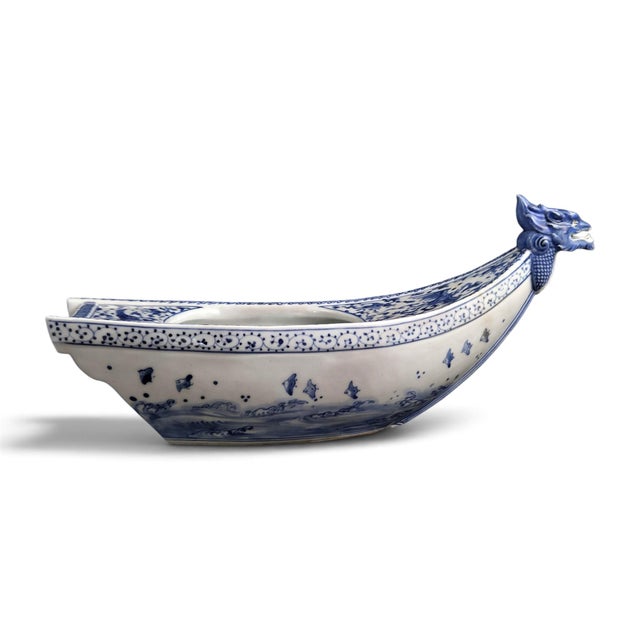 A late Meiji Japanese Mikawachi, or Hirado, porcelain dragon-head ship-form vessel, made c.1890–1910. The white porcelain...