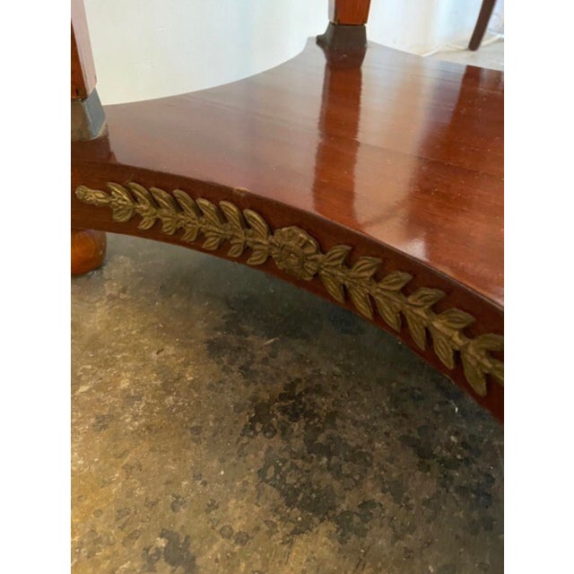 Marble top center table with applied bronze.