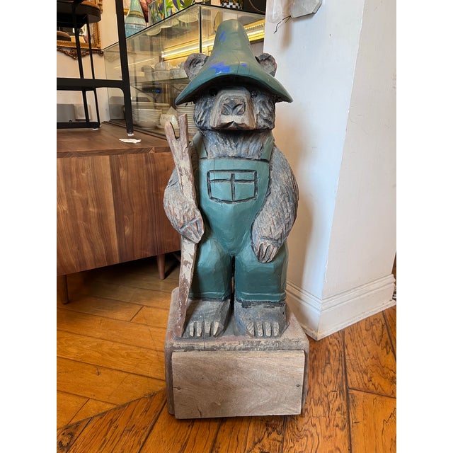 Design Plus Gallery presents a Hand Carved Mountain Bear Sculpture. This rustic figural carving depicts a standing bear...