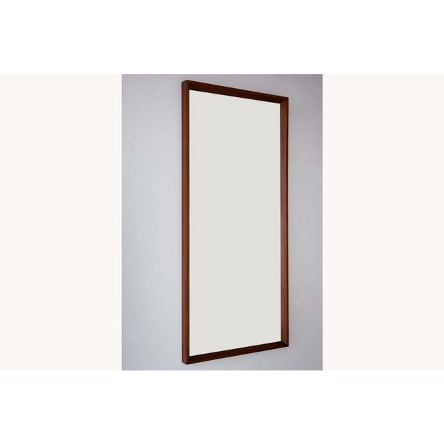 A long, Danish wall mirror with a pleasing chamfered teak frame. An understated and elegant mirror. Dimensions: Length...
