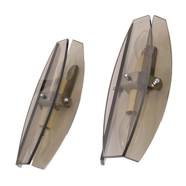 A pair of Italian sconces by Fontana Arte featuring panels of smoked, beveled glass. U.S. wired and in working condition....