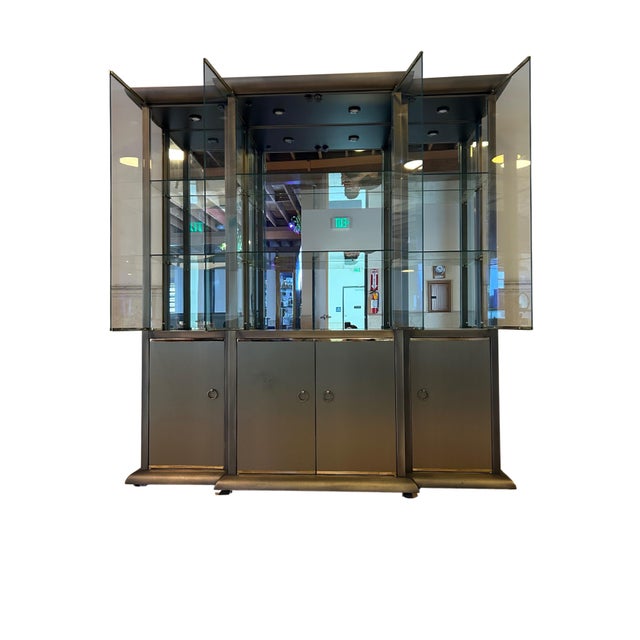 This striking 3-part display cabinet by Design Institute America showcases the brand’s signature blend of sleek modernism...