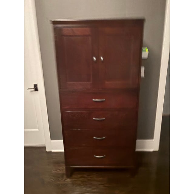 Ethan Allen Horizons collection storage cabinet in rich cherry finish. Features two upper doors opening to adjustable...
