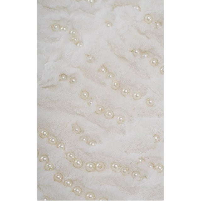 This off-white imitation rabbit fur lumbar pillow is filled with lightweight and fluffy feather velvet, offering an...