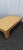 A beautifully proportioned vintage coffee table featuring a woven cane inset top framed by warm-toned wood. The...