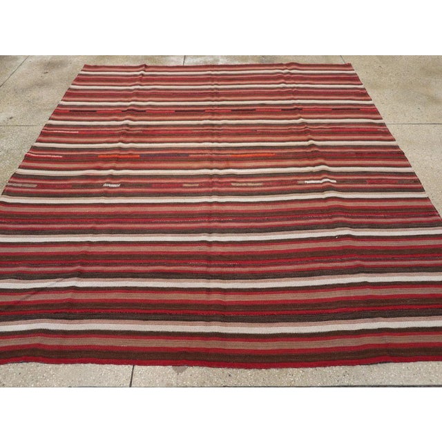 A vintage Turkish flatweave Kilim small room size carpet in square format handmade during the mid-20th century. Measures:...