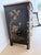 A black lacquer Chinoiserie bombe chest featuring hand-painted gilt Asian landscape scenes, ornate antique brass hardware,...