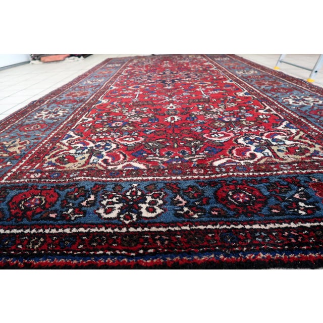 Experience the allure of the Handmade Vintage Persian Malayer Rug, a masterpiece from the 1960s. Design and Aesthetics:...