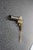 Antique flare gun manufactured by International Flare Signal Co., featuring a brass-finished body, dark iron barrel, and...