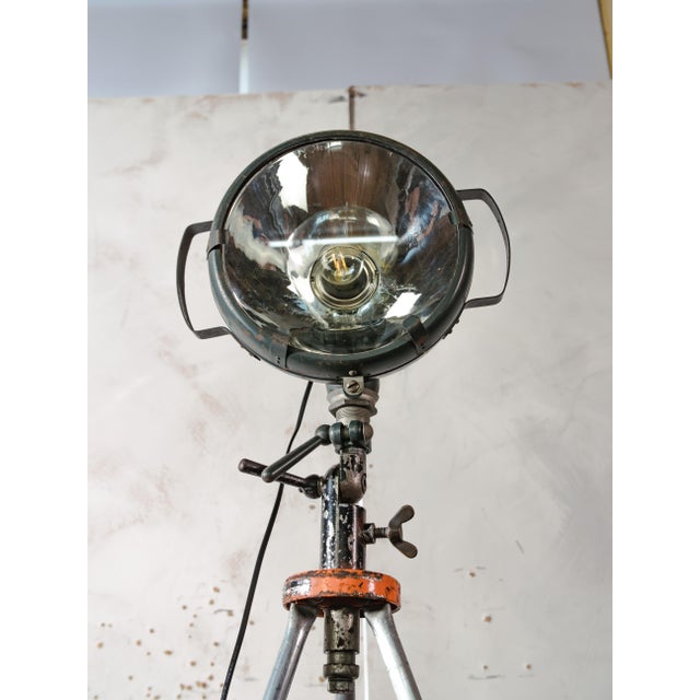 An industrial floor lamp built from an original Bosch Eisemann military searchlight, once used on military vehicles, as a...