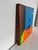 This surrealist-style painting depicts a vibrant, dreamlike landscape with a striking inverted reflection of melting,...