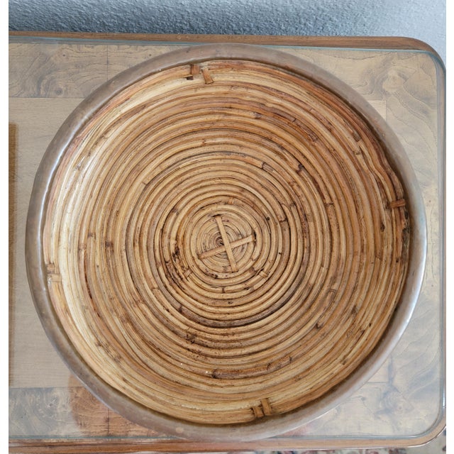 This is a mid-century bowl in pencil reed rattan with brass trim. This style of decorative basket was handcrafted in Italy...