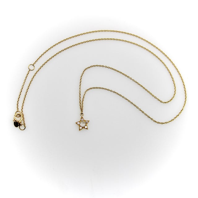 This tiny but very sweet star pendant is encrusted with six diamonds. The central diamond is a Rose Cut diamond, and each...