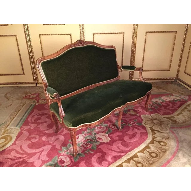 Solid walnut, hand-carved frame. Green velvet, historical upholstery in good condition.