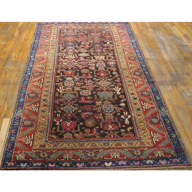 Antique Persian Tribal Kurdish rug, size: 4'6" x 8'4". Five amusing human figures are scattered within the rosettes and...