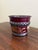 A wonderfully charming Mid-20th century French tole cachepot finished in a rich burgundy red with delicate gilt...
