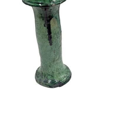 A Moroccan Tamegroute glazed candlestick holder is a handcrafted piece made in the historic pottery village of Tamegroute...