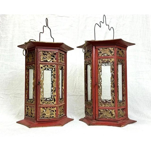 Pair of Asian Hand Carved Wooden Lanterns. Nice decorative pair in a rich cinnabar color. This pair is not identical but...