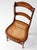 This antique Victorian cottage chair dates to the late 19th century and features a gently curved back with shaped...