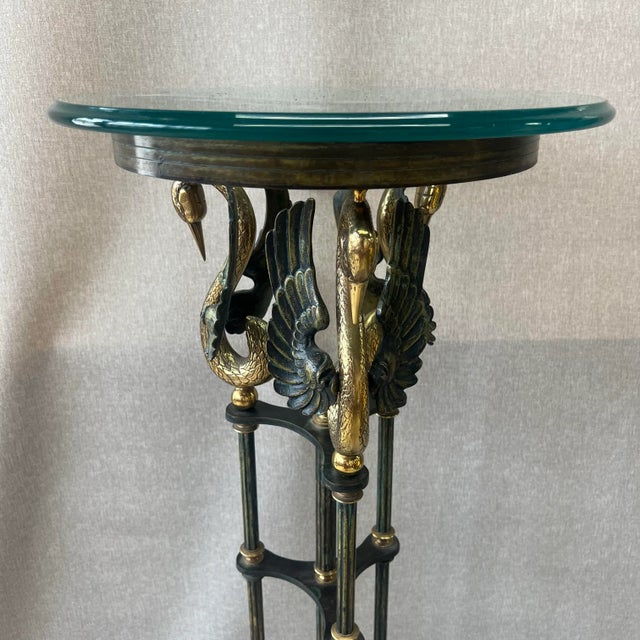 Magnificent Vintage Brass Swan Pedestal. The pedestal is made up of a glass top and a base crafted from brass with a...
