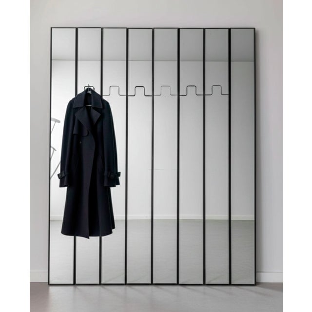 The Gronda, a large modular mirror and coat rack system, was designed by Luciano Bertoncini for Elco in Italy during the...