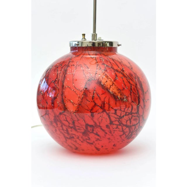 This stunning and gorgeous restored red, black, orange colored art deco glass lamp is from the fine and noted German metal...