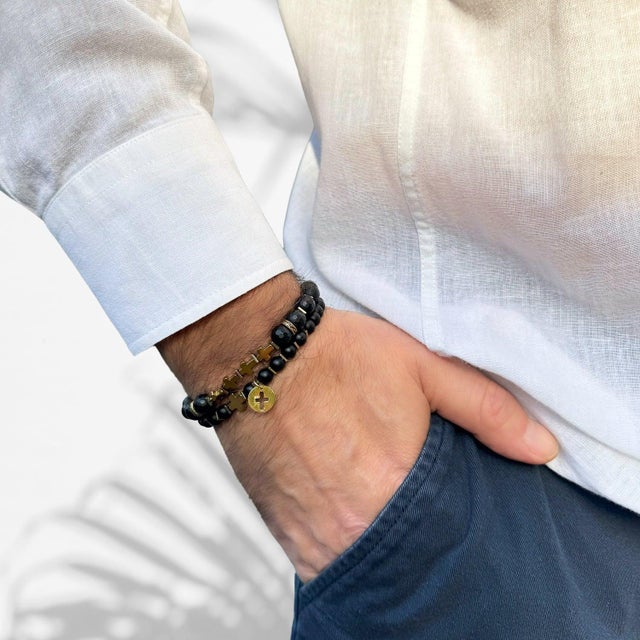 The Matte Black Onyx Stone Gold Cross Charm Wise Belief Bracelet Set is a sophisticated and stylish accessory designed for...
